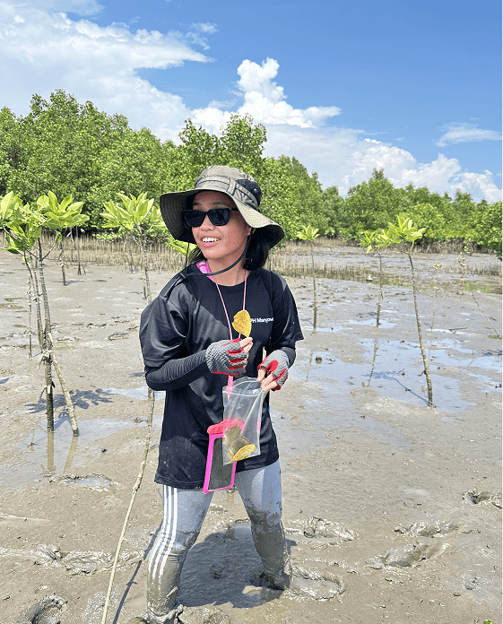 The artist with field gear among the mangroves.